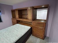 Full view of headboard wall unit showing centre and right sections against wall