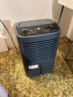 Front view of Whirlpool Gold Series dehumidifier showing grille, water tank slot and power cord