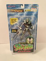 Front view of sealed Spawn The Curse figure in blister packaging