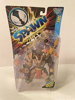 Front view of sealed Spawn Sabre figure in blister packaging