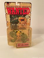 Front view of sealed Spat and Grovel figure on card