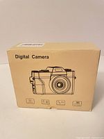 Front of closed retail box showing camera illustration and spec icons