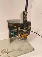 Front view showing digital display, power switch, handle, missing base
