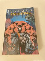 Front cover showing title BATMAN KNIGHTFALL Volume One with characters Bane and Batman