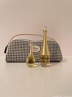 Front view of both perfume bottles and cosmetic bag