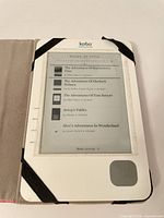 Kobo eReader powered on showing book list inside case