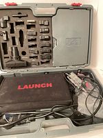 Open carrying case showing adapters, pouch, cables