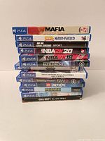 Stack of 13 PS4 game cases showing all titles