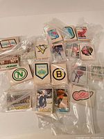 Multiple stacks of 1978-79 O-Pee-Chee hockey cards sorted in plastic bags with visible team logo cards