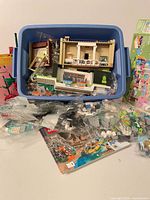 Blue tote with loose LEGO pieces and partial build