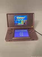 Nintendo DS Lite powered on displaying Garfield's Nightmare title screen