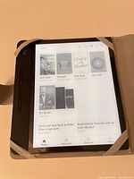 Front view of Kobo Forma eReader in case displaying home screen