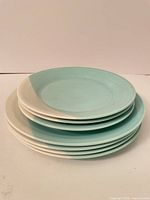Stack of seven aqua and white Royal Doulton plates