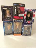 Group shot of six boxed vinyl figures showing fronts