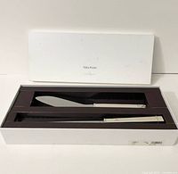 Open box displaying knife and trowel seated in insert