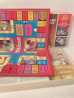 Box open showing bilingual game board and component tray