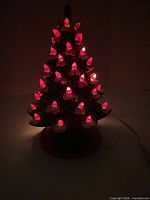Tree illuminated in dark showing red peg lights