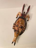 Full view of carved wooden horned mask
