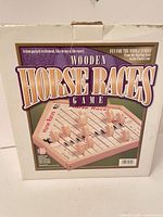 Front of boxed Wooden Horse Races Game showing components illustration