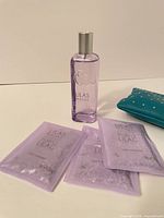 Fragrance bottle, bath salt packets, teal Ipsy bag overview