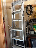 full view of the aluminum extension ladder leaning against wall