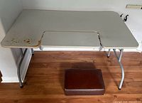 Overall view of folding computer table showing top, adjustable keyboard tray, and metal legs