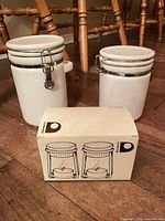 Both ceramic canisters with boxed Danesco butter warmers