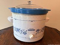 Front view of Rival Crock-Pot showing Delft Blue pattern, control dial, and glass lid
