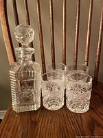 decanter and four tumblers on chair