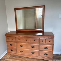 Front view of maple dresser and mirror showing drawer configuration and wood finish