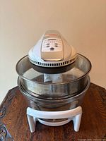 Full view of FlavorWave countertop oven showing lid, glass bowl, extender ring, and base