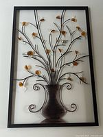 Full view of framed metal wall art showing design and condition