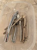 Plastic tub containing two nutcrackers and six nut picks