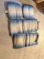 All four blue ombré vinyl cushions arranged on floor showing sizes and condition