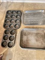 Muffin tins and two rectangular pans laid out