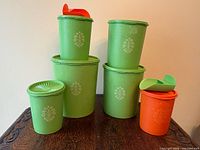All five Tupperware canisters and two scoops displayed on tabletop
