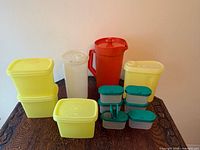All Tupperware items arranged on tabletop showing pitchers, storage containers and mini stackables