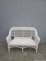 Front view of white vinyl wicker loveseat