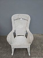 Front view of white wicker rocking chair