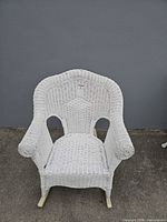 Front view of white wicker rocking chair
