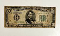 Obverse of note showing Lincoln portrait, serial number G39592809A, gold clause text
