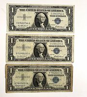 Fronts of three US $1 silver certificates, Series 1957 and 1957-B