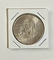 Obverse showing Miguel Hidalgo, denomination, year, silver purity, in flip