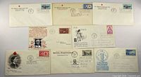 Group shot of nine vintage first day cover envelopes laid out in three rows