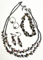 Full set laid out showing necklace, bracelet and both earring pairs