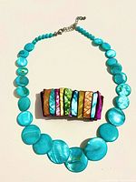 Turquoise shell necklace and multicolor shell bracelet laid flat