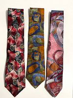 Three ties laid flat side-by-side showing front patterns