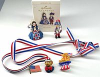 Front view of all items including clip earrings, ribbon necklace and three patriotic pins