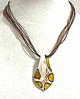 Front view on display bust showing pendant pattern and necklace strands