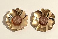Front view of both goldtone flower earrings showing design and centers